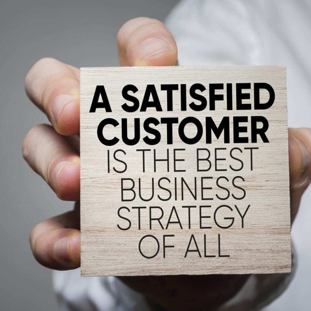 A hand holding a card with a business strategy quote. A hand holding a card with a business strategy quote.